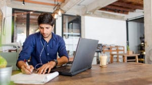 Young Man Taking Notes