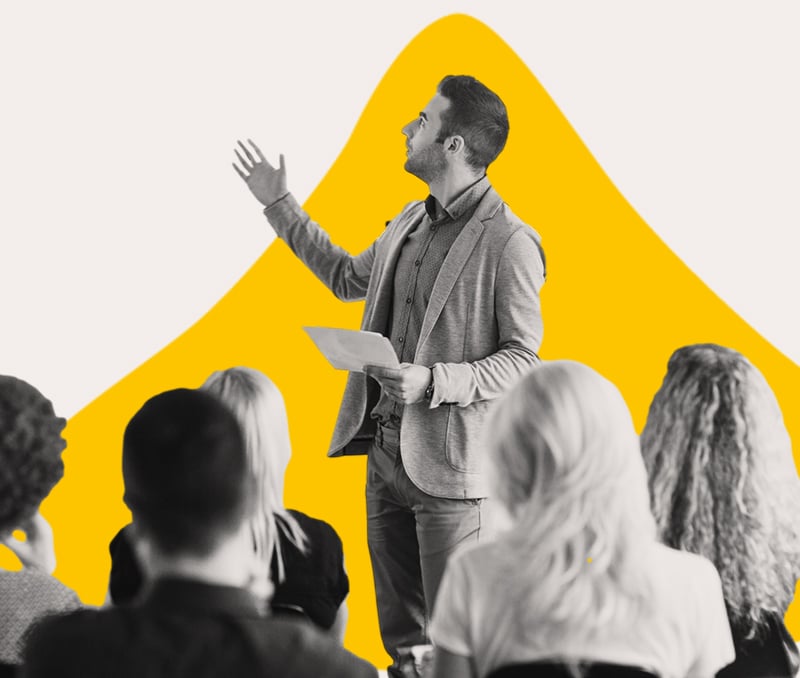 A Man Holding a Blank Sheet of Paper Giving a Presentation to a Group of People